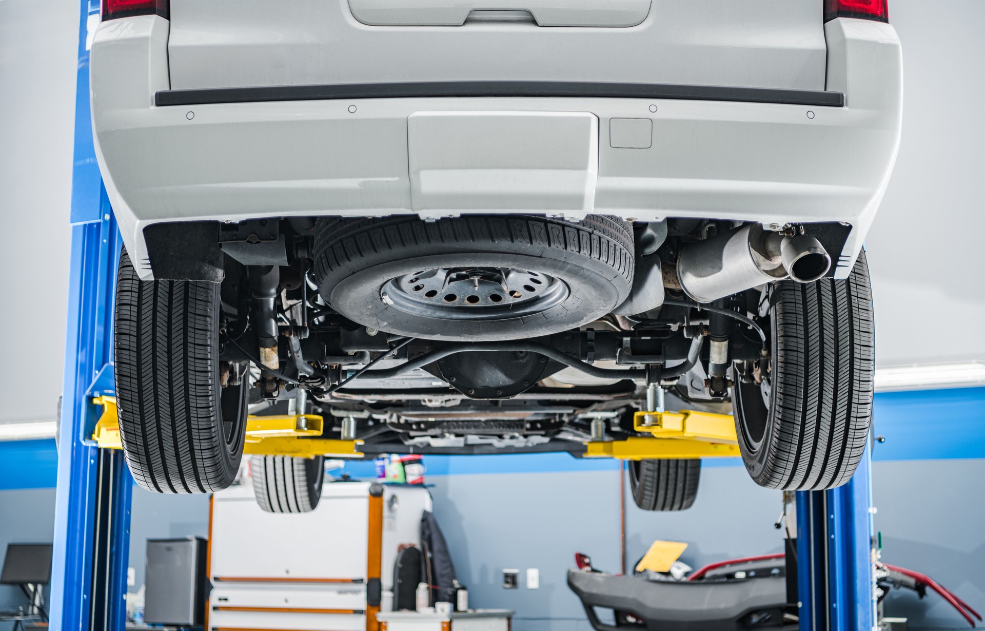 A Car on a Lift Inside Auto Service Shop